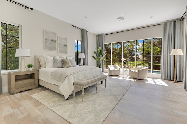 5157 Latrobe Dr, Windermere, FL 34786 - bedroom with multiple windows and light wood-style flooring
