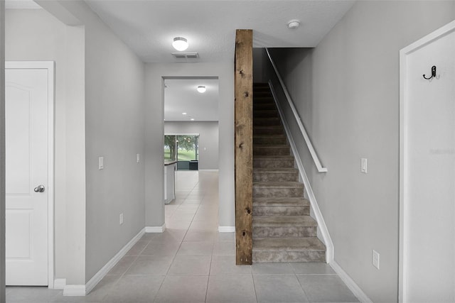 228 Primrose Dr, Davenport, FL 33837 - stairs with tile patterned floors, baseboards, and a textured ceiling