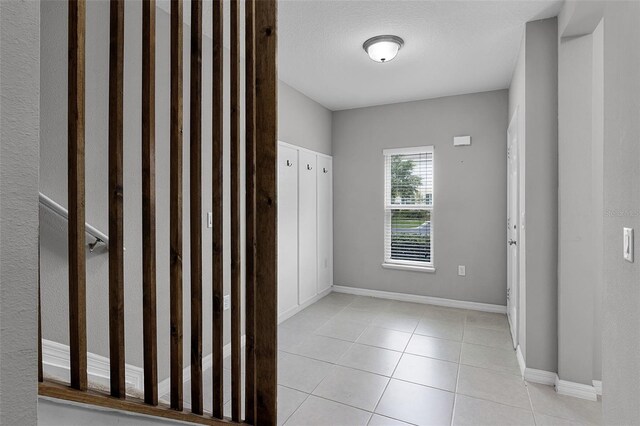 228 Primrose Dr, Davenport, FL 33837 - foyer featuring light tile patterned floors and baseboards