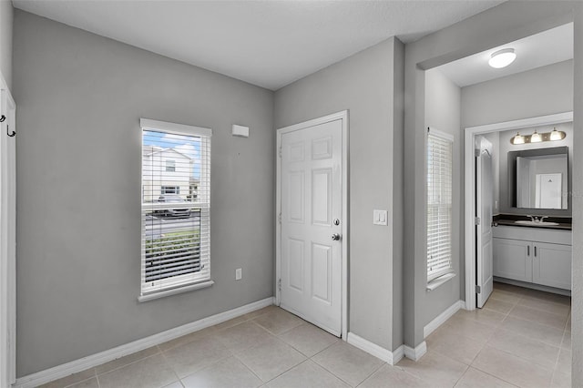 228 Primrose Dr, Davenport, FL 33837 - foyer entrance with light tile patterned floors and baseboards