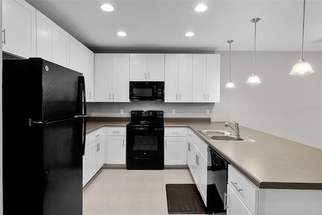 228 Primrose Dr, Davenport, FL 33837 - kitchen with black appliances, a sink, a peninsula, recessed lighting, and white cabinetry
