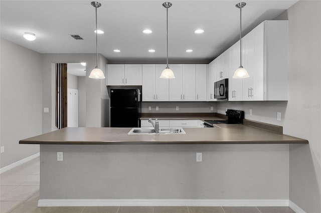 228 Primrose Dr, Davenport, FL 33837 - kitchen featuring black appliances, a sink, a peninsula, white cabinets, and recessed lighting