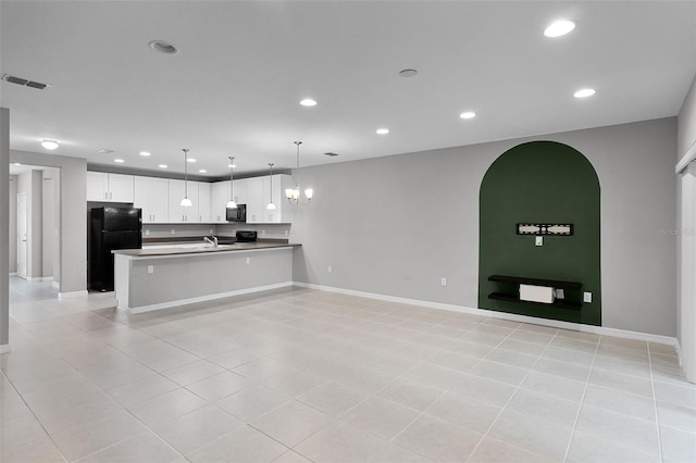 228 Primrose Dr, Davenport, FL 33837 - kitchen with freestanding refrigerator, open floor plan, light tile patterned floors, a peninsula, and recessed lighting