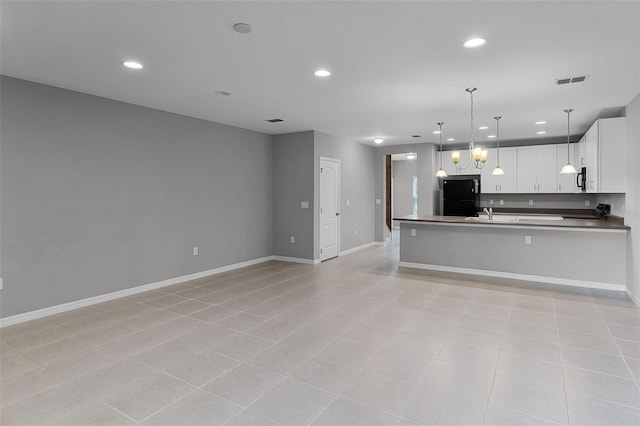 228 Primrose Dr, Davenport, FL 33837 - kitchen with black appliances, open floor plan, recessed lighting, a peninsula, and pendant lighting