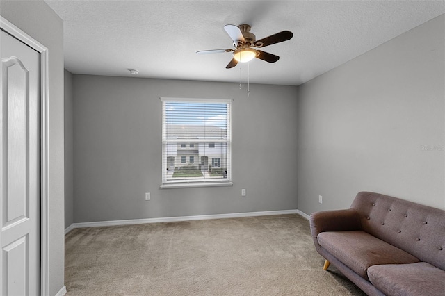 228 Primrose Dr, Davenport, FL 33837 - sitting room with carpet flooring, a ceiling fan, baseboards, and a textured ceiling