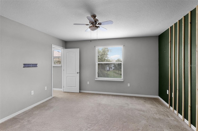 228 Primrose Dr, Davenport, FL 33837 - spare room featuring healthy amount of natural light, ceiling fan, carpet floors, baseboards, and a textured ceiling