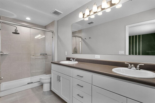 228 Primrose Dr, Davenport, FL 33837 - bathroom with tile patterned flooring, double vanity, a stall shower, toilet, and recessed lighting