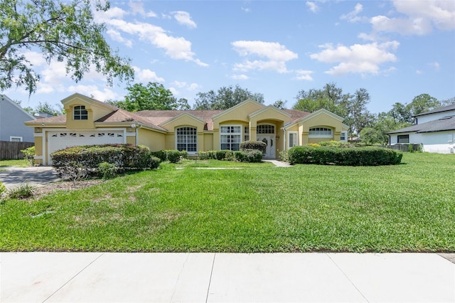 1910 Palm View Dr, Apopka, FL 32712 - view of front of property featuring stucco siding, concrete driveway, and a garage