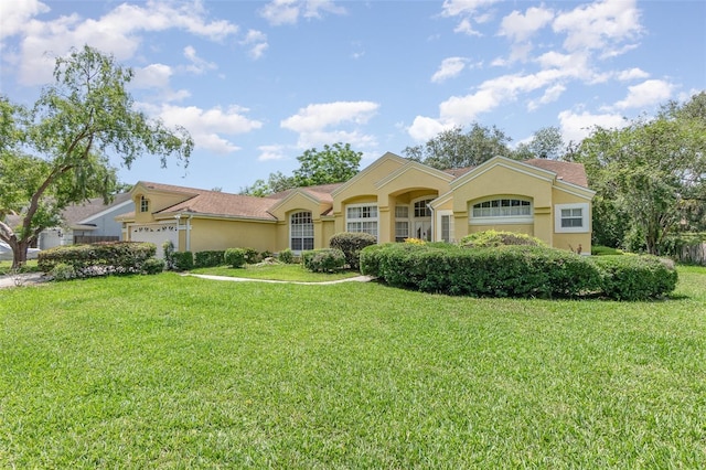 1910 Palm View Dr, Apopka, FL 32712 - view of front of home with stucco siding, a front lawn, and a garage