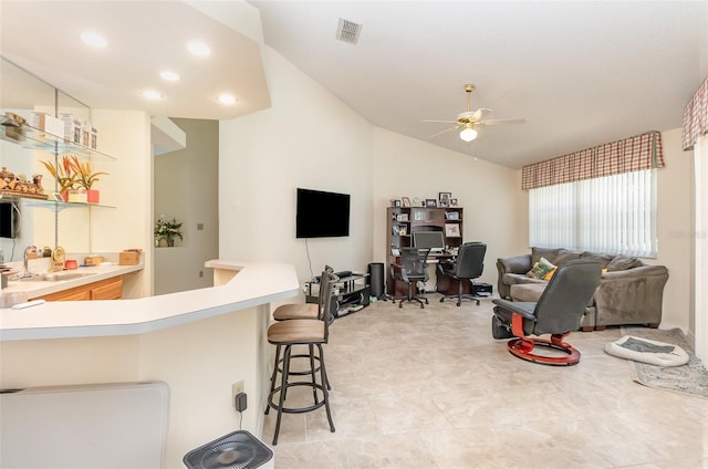 1910 Palm View Dr, Apopka, FL 32712 - kitchen with a sink, ceiling fan, lofted ceiling, a breakfast bar, and light countertops