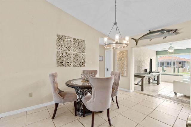109 Coral Reef Ct N, Palm Coast, FL 32137 - dining space featuring a chandelier, light tile patterned flooring, vaulted ceiling, and baseboards