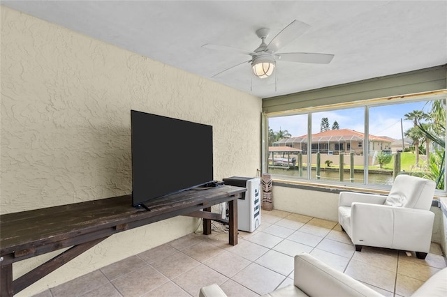 109 Coral Reef Ct N, Palm Coast, FL 32137 - living room featuring a textured wall, ceiling fan, light tile patterned floors, and a residential view