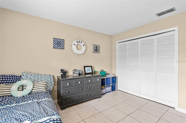 109 Coral Reef Ct N, Palm Coast, FL 32137 - bedroom with light tile patterned floors, a closet, and baseboards