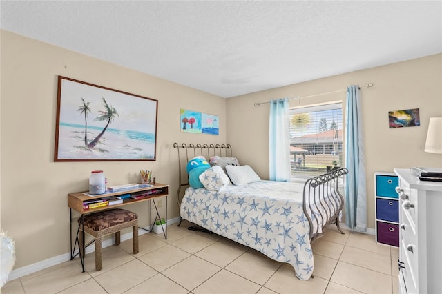 109 Coral Reef Ct N, Palm Coast, FL 32137 - bedroom with a textured ceiling, light tile patterned floors, and baseboards