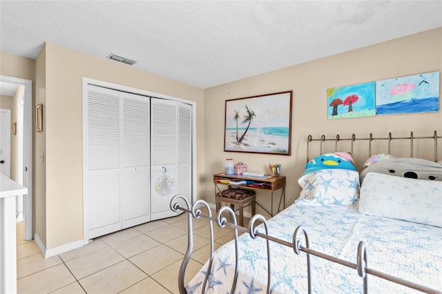 109 Coral Reef Ct N, Palm Coast, FL 32137 - bedroom featuring light tile patterned floors, a closet, and baseboards