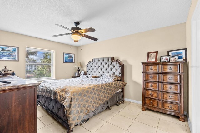 109 Coral Reef Ct N, Palm Coast, FL 32137 - bedroom featuring light tile patterned floors, ceiling fan, a textured ceiling, and baseboards