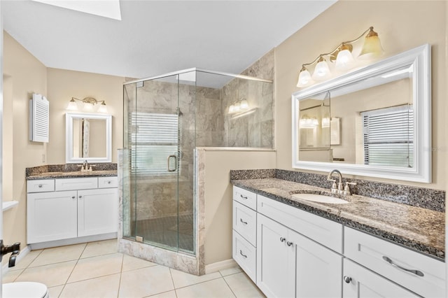 109 Coral Reef Ct N, Palm Coast, FL 32137 - full bathroom with a shower stall, two vanities, tile patterned floors, and healthy amount of natural light