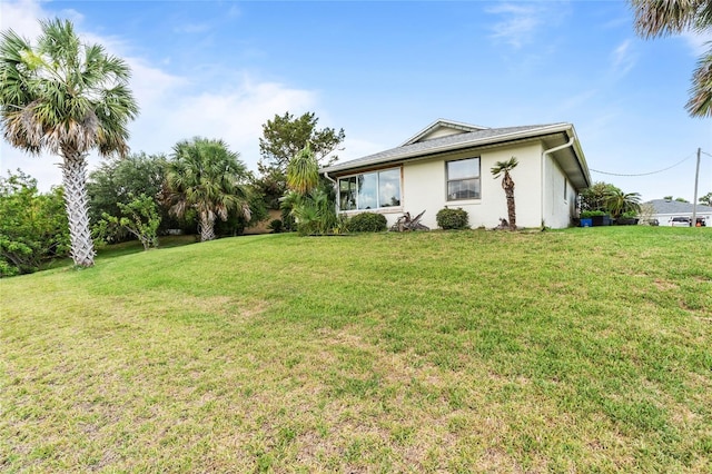 109 Coral Reef Ct N, Palm Coast, FL 32137 - rear view of house featuring a lawn and stucco siding