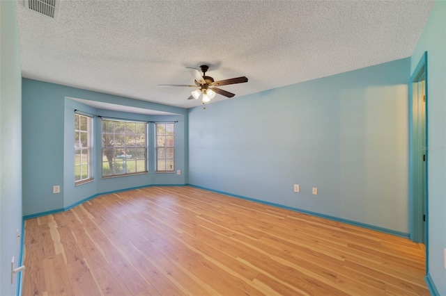 925 S Dean Cir, Deltona, FL 32738 - empty room with ceiling fan, light wood-style flooring, a textured ceiling, and baseboards