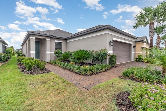 2342 Clemblue Rd, Clermont, FL 34715 - view of side of home with stucco siding, a yard, an attached garage, and driveway