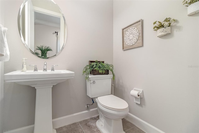 2342 Clemblue Rd, Clermont, FL 34715 - bathroom featuring toilet, tile patterned floors, baseboards, and a sink