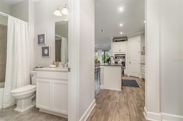 2342 Clemblue Rd, Clermont, FL 34715 - bathroom with vanity, toilet, wood finished floors, shower / tub combo with curtain, and recessed lighting