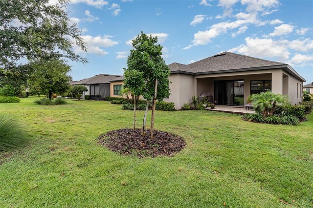 2342 Clemblue Rd, Clermont, FL 34715 - back of property with a lawn, stucco siding, a patio area, and a shingled roof