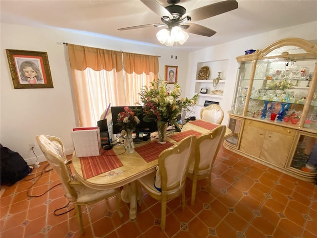 dining space featuring built in shelves and a ceiling fan