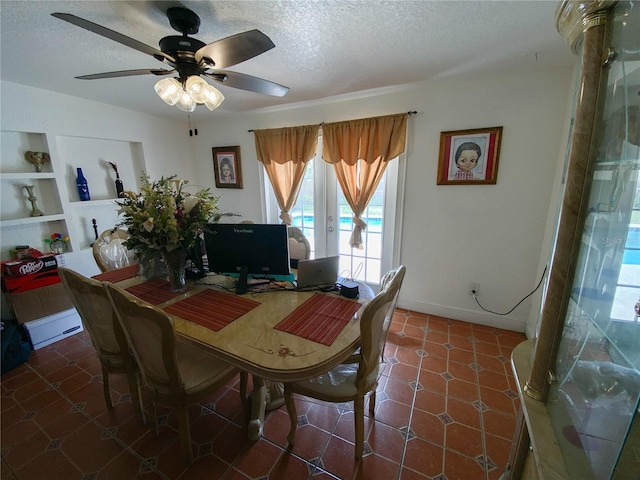 dining space with a textured ceiling, healthy amount of natural light, ceiling fan, built in features, and baseboards