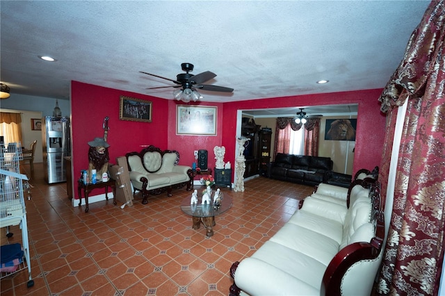 living room featuring ceiling fan, recessed lighting, and a textured ceiling