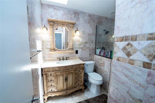 full bath with tile walls, toilet, vanity, and a tile shower