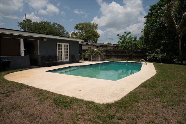 view of swimming pool with french doors and a patio area