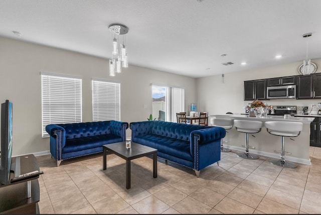 601 Watusi Way, Saint Cloud, FL 34772 - living room with light tile patterned floors, baseboards, and recessed lighting