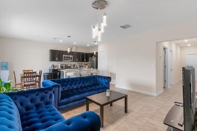 601 Watusi Way, Saint Cloud, FL 34772 - living room featuring light tile patterned floors, recessed lighting, and baseboards