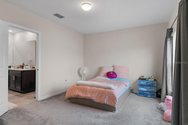 601 Watusi Way, Saint Cloud, FL 34772 - bedroom featuring light carpet, baseboards, and ensuite bath