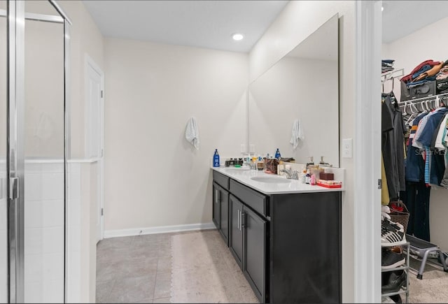 601 Watusi Way, Saint Cloud, FL 34772 - bathroom with vanity, a walk in closet, a stall shower, and baseboards
