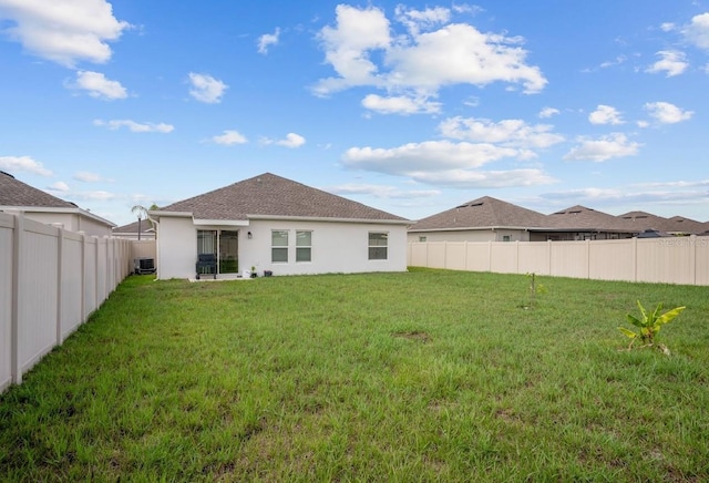 601 Watusi Way, Saint Cloud, FL 34772 - rear view of house featuring stucco siding and central AC
