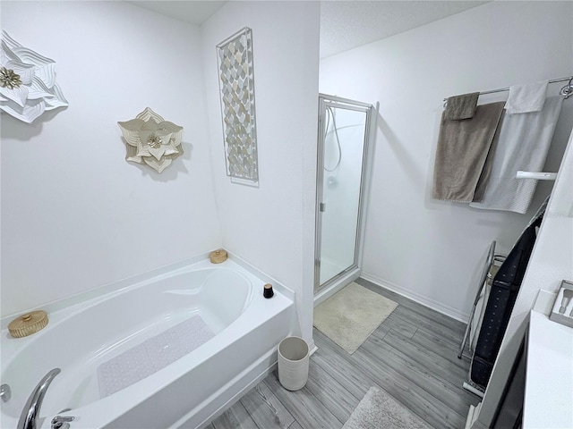 1713 Redfin Way, Kissimmee, FL 34759 - full bath with a garden tub, a shower stall, and wood finished floors