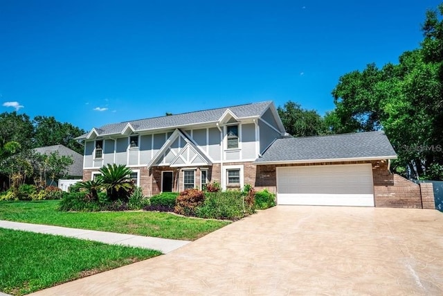3009 Ridgevale Cir, Valrico, FL 33596 - english style home with concrete driveway, an attached garage, brick siding, a front lawn, and stucco siding