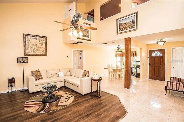 3009 Ridgevale Cir, Valrico, FL 33596 - living room with ceiling fan, baseboards, and a towering ceiling