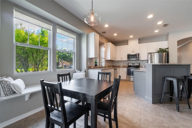 3223 Blazing Star Ln, Harmony, FL 34773 - dining space with light tile patterned floors, recessed lighting, and baseboards