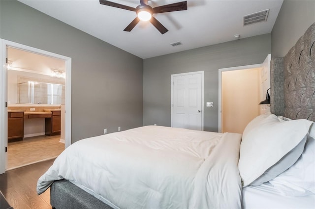 3223 Blazing Star Ln, Harmony, FL 34773 - bedroom with wood finished floors, connected bathroom, and a ceiling fan