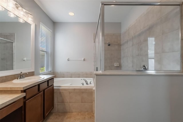 3223 Blazing Star Ln, Harmony, FL 34773 - bathroom with vanity, walk in shower, a garden tub, and plenty of natural light