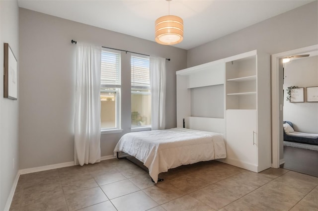 3223 Blazing Star Ln, Harmony, FL 34773 - bedroom with baseboards and light tile patterned floors