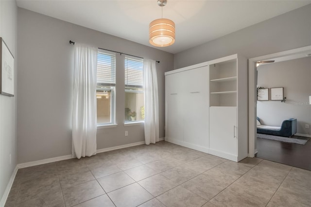 3223 Blazing Star Ln, Harmony, FL 34773 - unfurnished bedroom featuring light tile patterned floors and baseboards