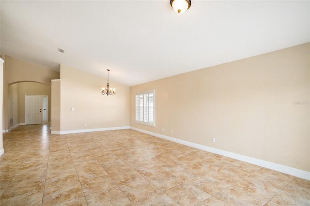 2830 Alton Dr, Kissimmee, FL 34741 - empty room featuring vaulted ceiling, a chandelier, arched walkways, baseboards, and light tile patterned floors
