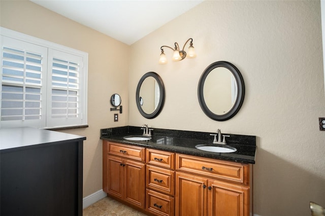 2830 Alton Dr, Kissimmee, FL 34741 - full bathroom featuring double vanity and baseboards