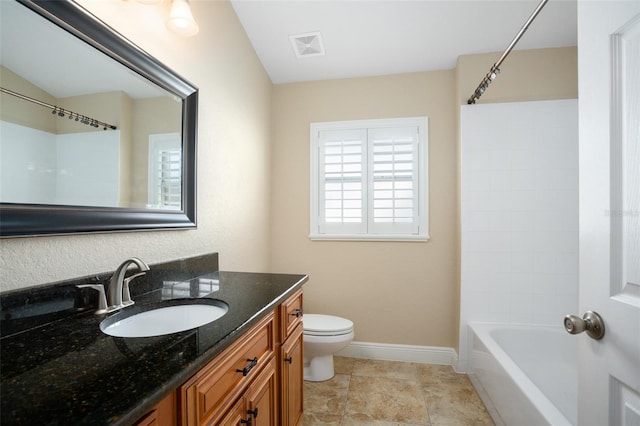 2830 Alton Dr, Kissimmee, FL 34741 - bathroom featuring vanity, toilet, baseboards, and shower / washtub combination