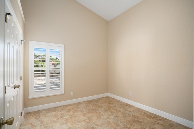 2830 Alton Dr, Kissimmee, FL 34741 - spare room featuring baseboards and high vaulted ceiling