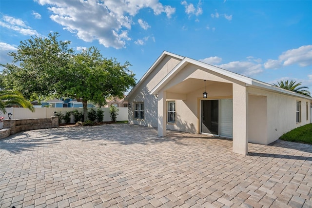 2830 Alton Dr, Kissimmee, FL 34741 - rear view of property with a patio area and stucco siding